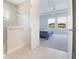 Bright bathroom showcasing a glass-enclosed shower and a glimpse of a bedroom with scenic views at 13246 Twin Bridges Dr, Riverview, FL 33579