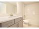 Bright bathroom with gray vanity, modern fixtures, and a tub-shower combination at 13246 Twin Bridges Dr, Riverview, FL 33579
