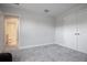 Carpeted bedroom offers ample space and doorway to the en-suite bathroom at 13246 Twin Bridges Dr, Riverview, FL 33579