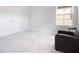 Neutral bedroom with large window and cozy chair, creating a relaxing space at 13246 Twin Bridges Dr, Riverview, FL 33579