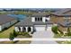 Beautiful two-story home with a three-car garage, lush landscaping, and serene water view at 13246 Twin Bridges Dr, Riverview, FL 33579