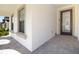 Covered front porch with stylish pavers leading to an elegant front door and window details at 13246 Twin Bridges Dr, Riverview, FL 33579