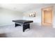 Upstairs game room with TV, ping pong table, and neutral carpeting, ideal for leisure at 13246 Twin Bridges Dr, Riverview, FL 33579