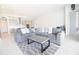 Open-concept living area connecting kitchen and dining area with a large sofa and patterned rug on light hardwood floors at 13246 Twin Bridges Dr, Riverview, FL 33579