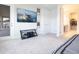 Spacious carpeted main bedroom with TV, access to a patio, and a glimpse into the walk-in closet at 13246 Twin Bridges Dr, Riverview, FL 33579