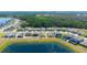 Aerial view of backyards lining a lake with screened in pools and lush landscaping at 13246 Twin Bridges Dr, Riverview, FL 33579