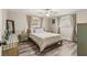 Charming bedroom features hardwood floors, a ceiling fan, and ample natural light from dual windows at 1344 Dartmouth Dr, Holiday, FL 34691