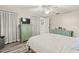 Bright bedroom features hardwood floors, ceiling fan, and custom closet storage at 1344 Dartmouth Dr, Holiday, FL 34691