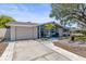 Single Gathering home features a well-maintained lawn and inviting curb appeal at 1344 Dartmouth Dr, Holiday, FL 34691