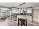 Modern eat-in kitchen features stainless appliances, beautiful backsplash, and stylish pendant lighting at 1344 Dartmouth Dr, Holiday, FL 34691
