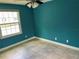 Bright bedroom featuring blue walls, tile flooring, ceiling fan and a window providing natural light at 13833 Orange Sunset Dr # 201, Tampa, FL 33618