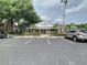 Exterior of a well-maintained clubhouse with ample parking, nestled among lush greenery at 13833 Orange Sunset Dr # 201, Tampa, FL 33618
