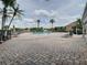Community pool with brick pavers and lounge chairs offering a relaxing retreat, under a partly cloudy sky at 13833 Orange Sunset Dr # 201, Tampa, FL 33618