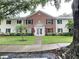 Inviting two-story condo complex with manicured lawn and lush landscaping around the front walkway entrance at 13833 Orange Sunset Dr # 201, Tampa, FL 33618
