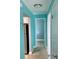 Hallway view showcases tiled floors and a glimpse into the kitchen and bedrooms at 13833 Orange Sunset Dr # 201, Tampa, FL 33618