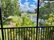 Scenic view of a tranquil pond with fountain, framed by tropical greenery from a screened-in lanai at 13833 Orange Sunset Dr # 201, Tampa, FL 33618