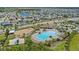An aerial view of the community featuring a resort-style pool, playground, and beautiful single-Gathering homes surrounding the lake at 13871 Carlow Park Dr, Riverview, FL 33579
