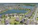 Expansive aerial view of a community with multiple homes surrounding a large lake at 13871 Carlow Park Dr, Riverview, FL 33579
