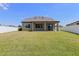The large backyard has a white vinyl fence and covered patio at 13871 Carlow Park Dr, Riverview, FL 33579