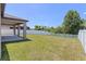 The backyard features lush grass and a white vinyl fence for added privacy at 13871 Carlow Park Dr, Riverview, FL 33579
