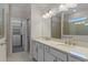 Bathroom featuring a double vanity, large mirror, and access to the walk-in closet and shower at 13871 Carlow Park Dr, Riverview, FL 33579