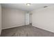 Bedroom boasts soft carpeting, neutral paint, and an open door at 13871 Carlow Park Dr, Riverview, FL 33579