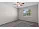 This bedroom features carpet flooring, a ceiling fan, and a window with natural light at 13871 Carlow Park Dr, Riverview, FL 33579