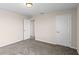 Bedroom boasts soft carpeting, neutral paint, and an open door at 13871 Carlow Park Dr, Riverview, FL 33579