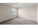 Bedroom features soft carpeting and window overlooking backyard at 13871 Carlow Park Dr, Riverview, FL 33579