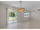 Open dining area with tile flooring, modern lighting, and sliding glass doors to the backyard at 13871 Carlow Park Dr, Riverview, FL 33579