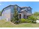 Charming two-story home with a stone facade, lovely landscaping, a two-car garage, and a well-manicured front yard at 13871 Carlow Park Dr, Riverview, FL 33579
