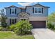 Inviting two-story home with a stone facade, two-car garage, and manicured landscaping for great curb appeal at 13871 Carlow Park Dr, Riverview, FL 33579