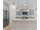 Charming kitchen with stainless steel appliances, gray cabinets, and a center island with quartz countertops at 13871 Carlow Park Dr, Riverview, FL 33579