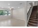 Spacious living room with tile flooring, stairs, large window and ceiling fan at 13871 Carlow Park Dr, Riverview, FL 33579