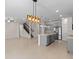Open-concept living room features tile floors, modern lighting, and a gray kitchen with stainless steel appliances at 13871 Carlow Park Dr, Riverview, FL 33579