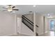 Spacious living room with tile flooring, staircase, and stylish ceiling fan at 13871 Carlow Park Dr, Riverview, FL 33579