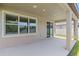 Covered patio with concrete flooring and large window overlooking backyard at 13871 Carlow Park Dr, Riverview, FL 33579