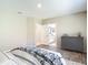 Bright bedroom showcasing wood-look floors, dresser, and ensuite bathroom access at 14020 Sooty Tern Ave, Brooksville, FL 34614