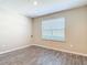 Bright bedroom with wood-look floors featuring neutral paint, window with blinds, and natural light at 14020 Sooty Tern Ave, Brooksville, FL 34614