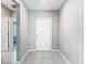 Bright foyer with tile flooring and a crisp white door, welcoming guests into the home at 14020 Sooty Tern Ave, Brooksville, FL 34614