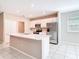 Modern kitchen featuring white cabinets, stainless steel appliances, a central island, and lots of light at 14020 Sooty Tern Ave, Brooksville, FL 34614