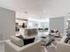 Open-concept living space featuring a modern kitchen with a breakfast bar seamlessly connected to the cozy living area at 14020 Sooty Tern Ave, Brooksville, FL 34614