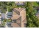 An aerial view of a property, showcasing the roofline, driveway, and landscaping at 14418 Mirabelle Vista Cir, Tampa, FL 33626
