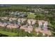 Aerial shot of residential homes surrounded by mature trees, community pool and tennis courts at 14418 Mirabelle Vista Cir, Tampa, FL 33626