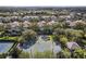 Overhead view of a basketball court surrounded by lush trees and residential homes, creating a private recreational space at 14418 Mirabelle Vista Cir, Tampa, FL 33626