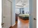 Bedroom with a queen bed, tray ceiling, and hardwood floors at 14418 Mirabelle Vista Cir, Tampa, FL 33626