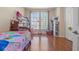 Bright bedroom featuring hardwood floors, natural light, and ample storage space at 14418 Mirabelle Vista Cir, Tampa, FL 33626