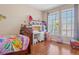 bedroom with wooden floors, a desk, and a window at 14418 Mirabelle Vista Cir, Tampa, FL 33626