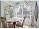 Sunlit breakfast nook with a round table and decorative curtains framing the window at 14418 Mirabelle Vista Cir, Tampa, FL 33626