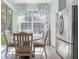 Cozy breakfast nook with a round table, natural light, and stainless steel refrigerator at 14418 Mirabelle Vista Cir, Tampa, FL 33626